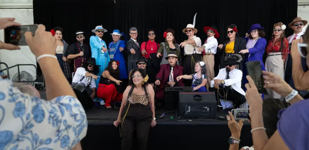 Zoot suit models gather for an end-of-fashion-show photo-op at the...