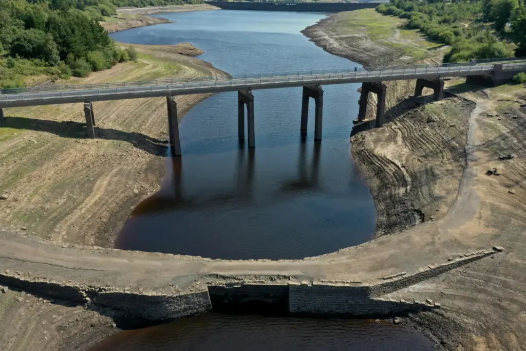The historic packhorse bridge at Baitings Reservoir near Sowerby Bridge is exposed.