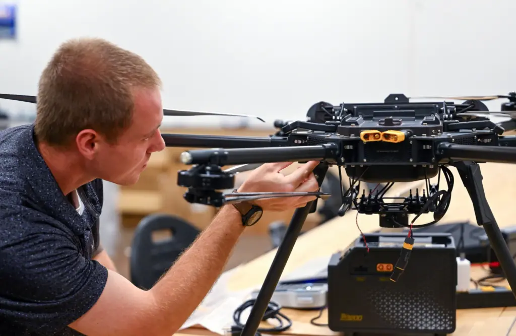 Nicholas Stafford works to inventory equipment at the Fullerton Drone...