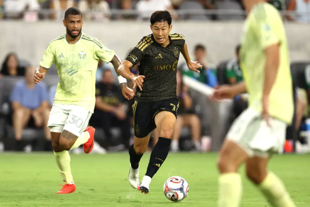 LAFC forward Son Heung-Min, center, dribbles the ball against the...