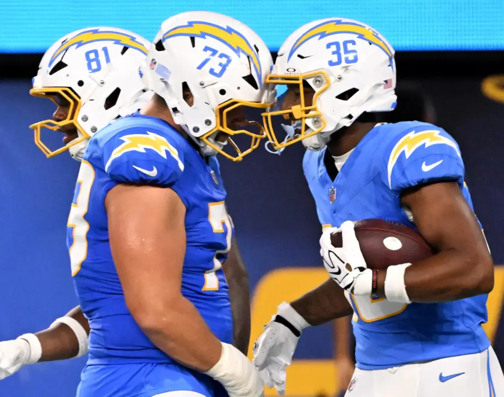 Chargers tight end Jerand Bradley, right, celebrates with guard Alex...