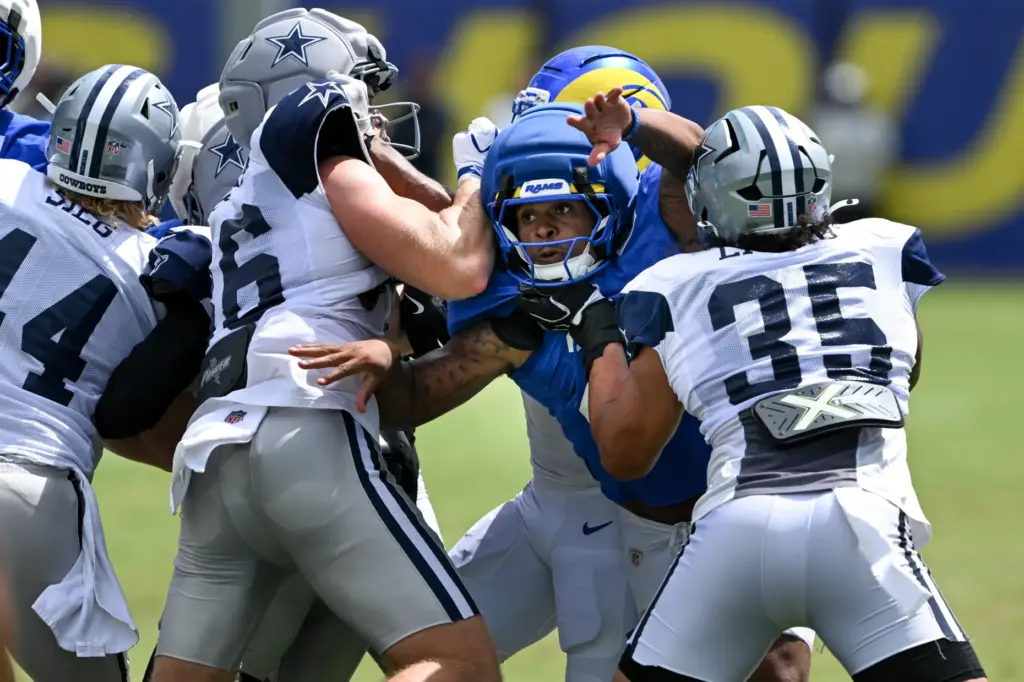 Rams running back Jarquez Hunter (27) goes up against Dallas...