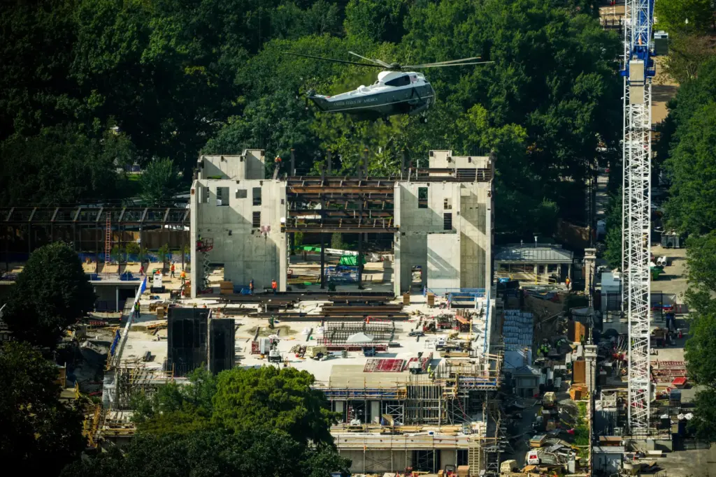 Marine One with President Donald Trump passes over construction on the new White House ballroom.