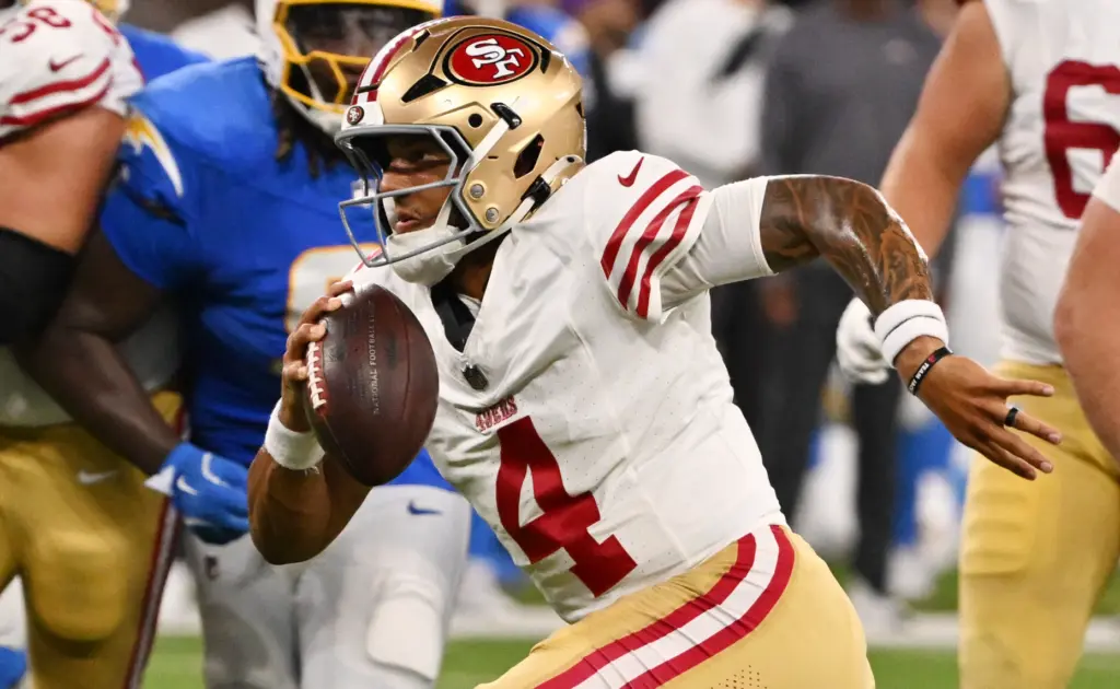 San Francisco 49ers quarterback Adrian Martinez scrambles for a 9-yard...