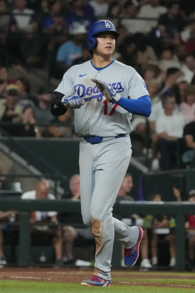 Dodgers star Shohei Ohtani walks back to the dugout during...