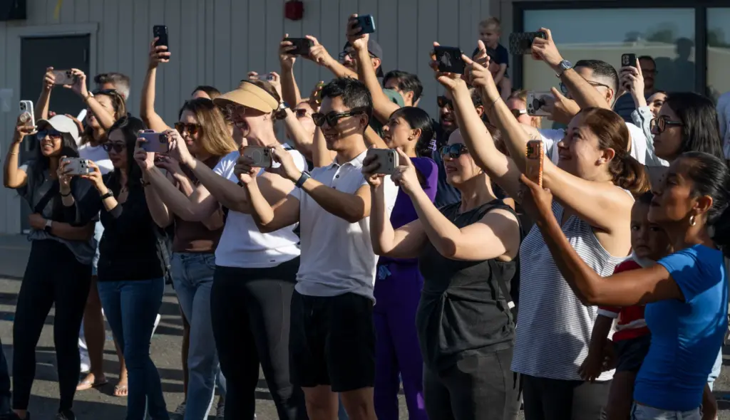 Parents take a class photo of their kids during the...