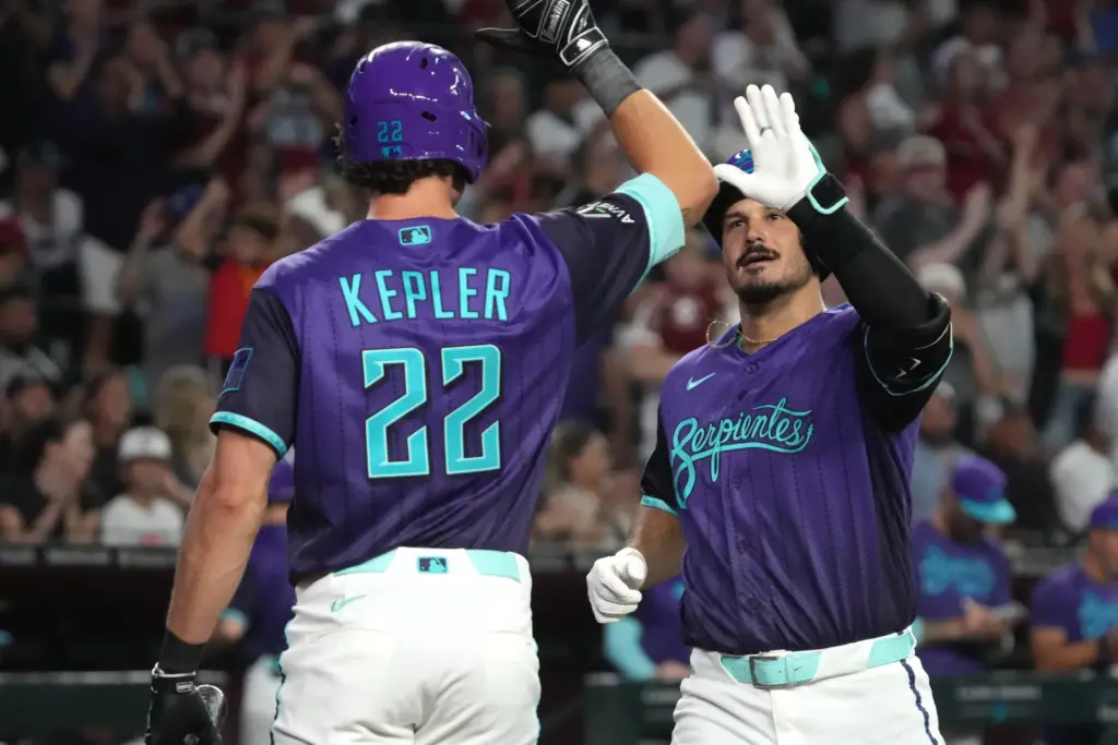 The Arizona Diamondbacks’ Nolan Arenado, right, celebrates with teammate Max...