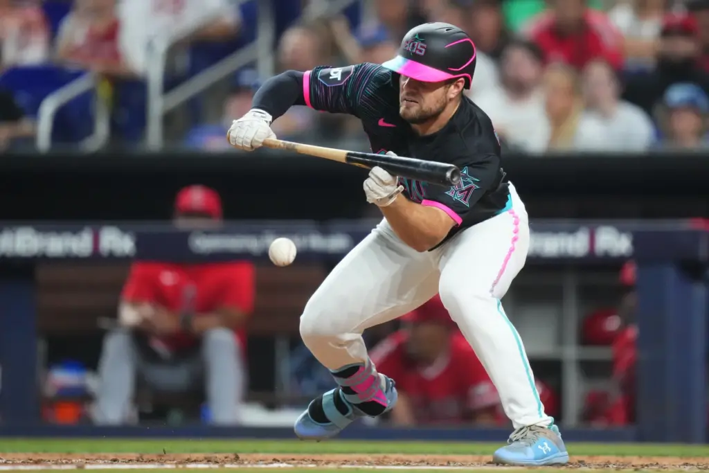 The Miami Marlins’ Jakob Marsee bunts for a single during...