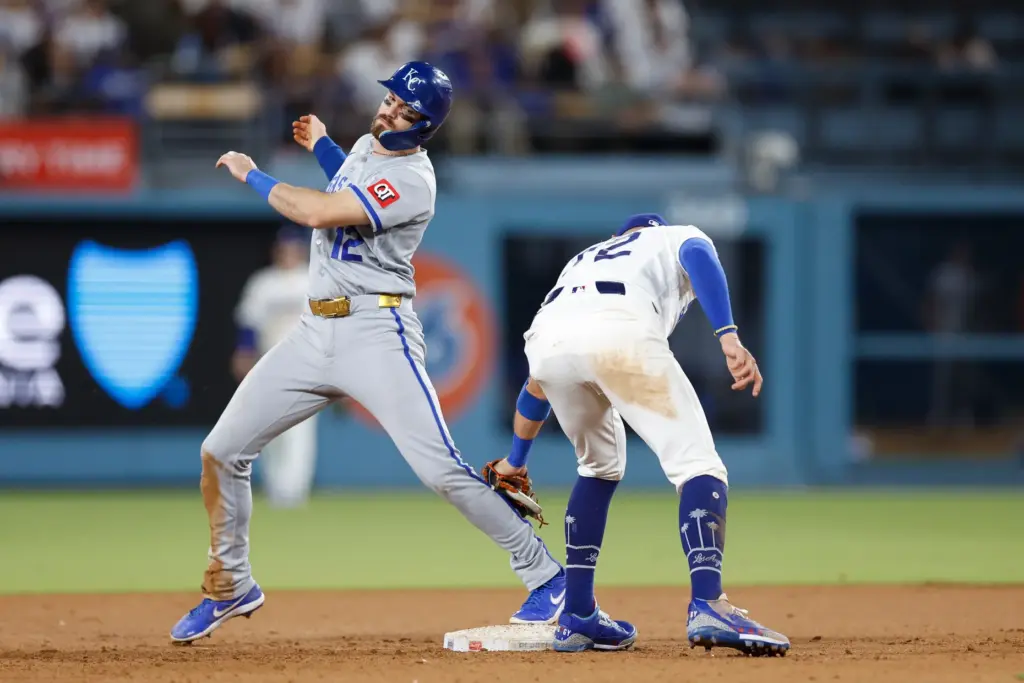 Dodgers second baseman Miguel Rojas, right, reaches to tag out...