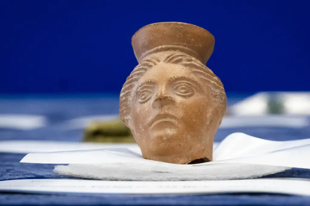 A pottery vessel in shape of human head from the...