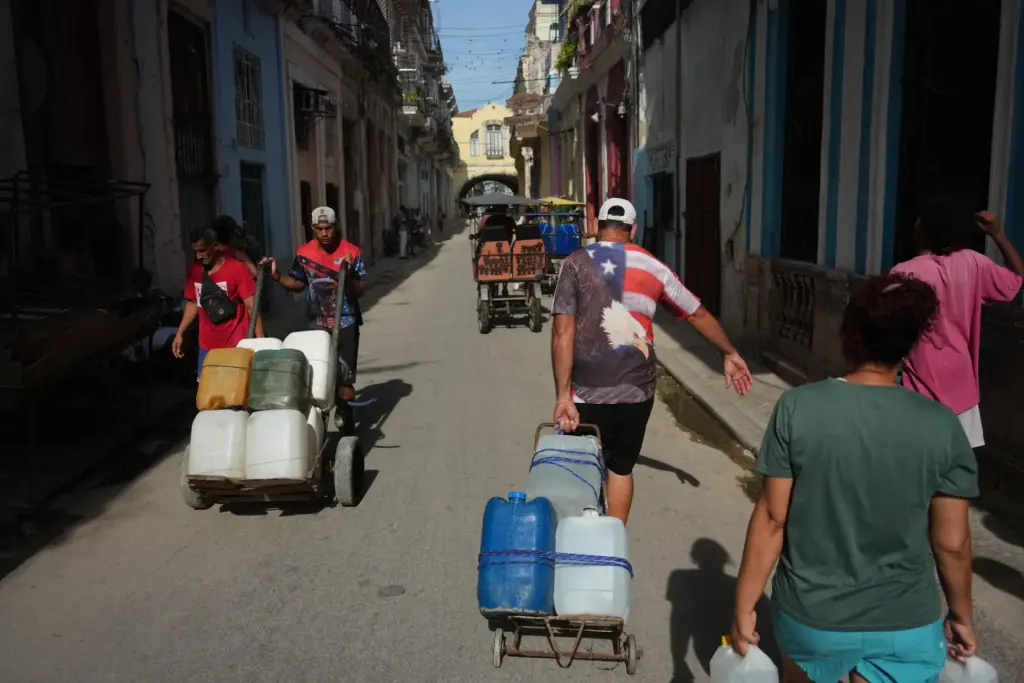 People carry water during a power outage in Havana, Cuba.