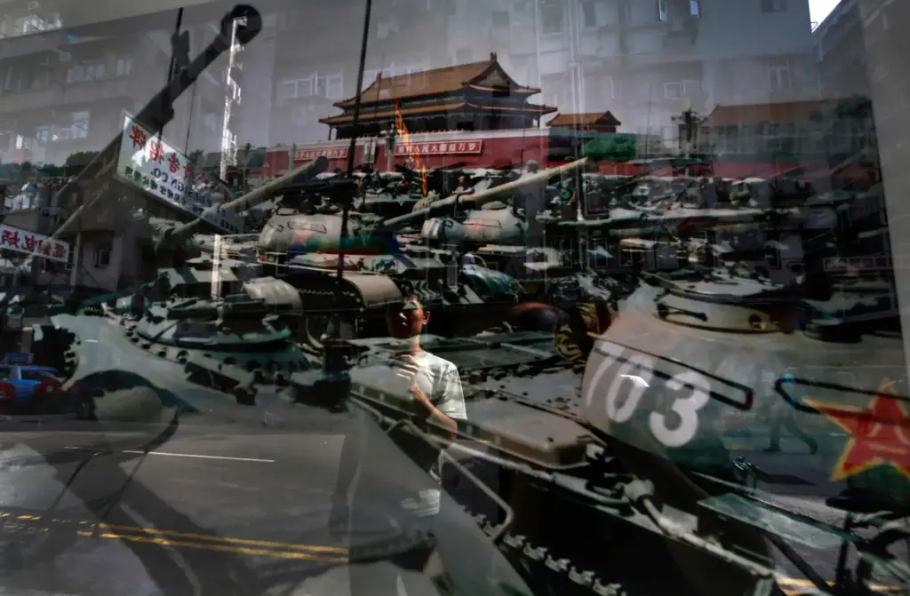 A man looks at a photo, believed to be taken by a former People's Liberation Army soldier.