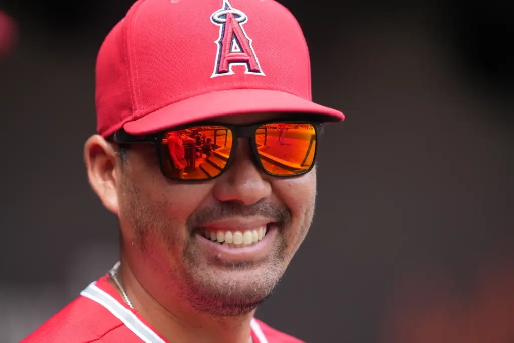 Angels manager Kurt Suzuki looks on from the dugout during...