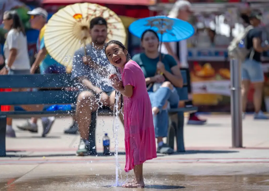 Emma Jimenez, 6, of Santa Ana cools off in a...