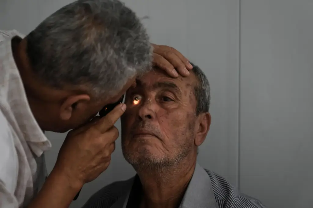 Bassam Musleh gets his eyes checked at a mobile health clinic.