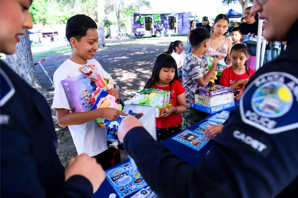 Kids load up on free goodies given out by the...