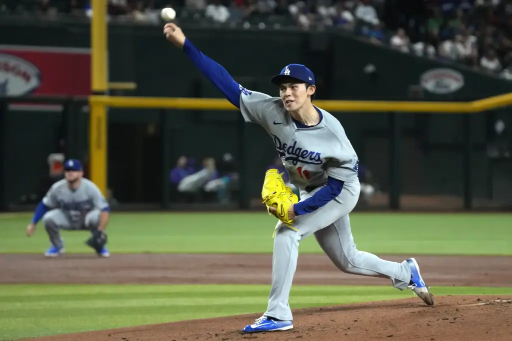 Dodgers starting pitcher Roki Sasaki throws to the plate during...