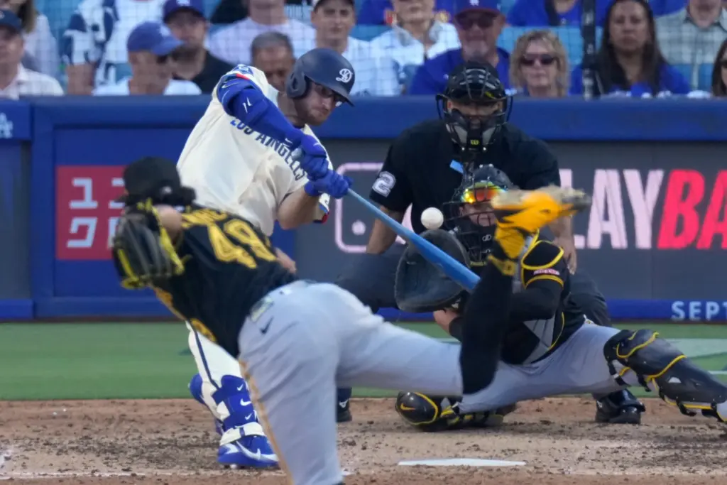 Dodgers’ Max Muncy, second from left, hits a double as...