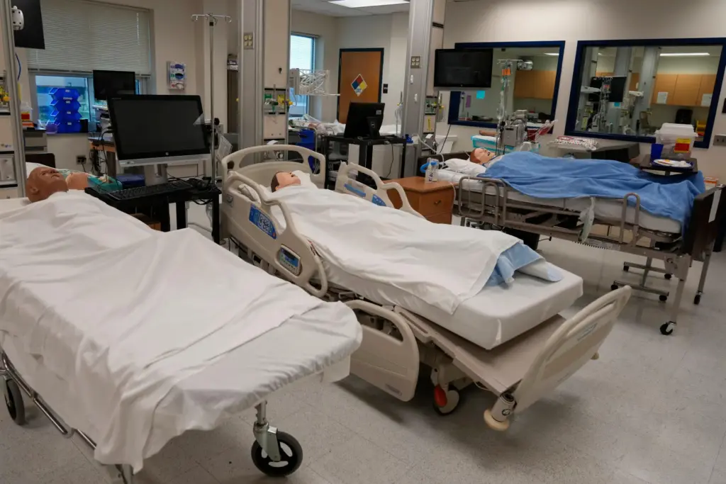 Manikins lay in hospital beds in the simulation lab.