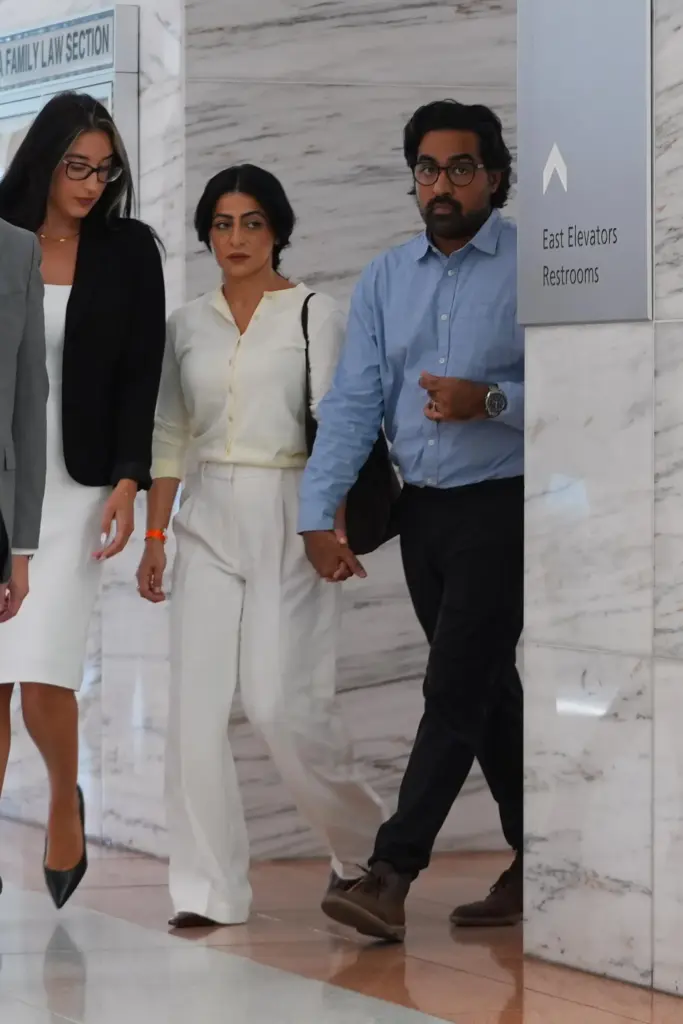 Omar Ahmed, right, and his wife Nausheen Gilkar, center, arrive...