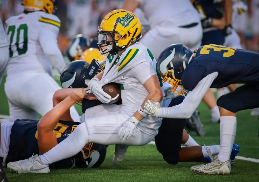 Brea Olindaâs (28) Brandon Bartell, middle, is brought down by...