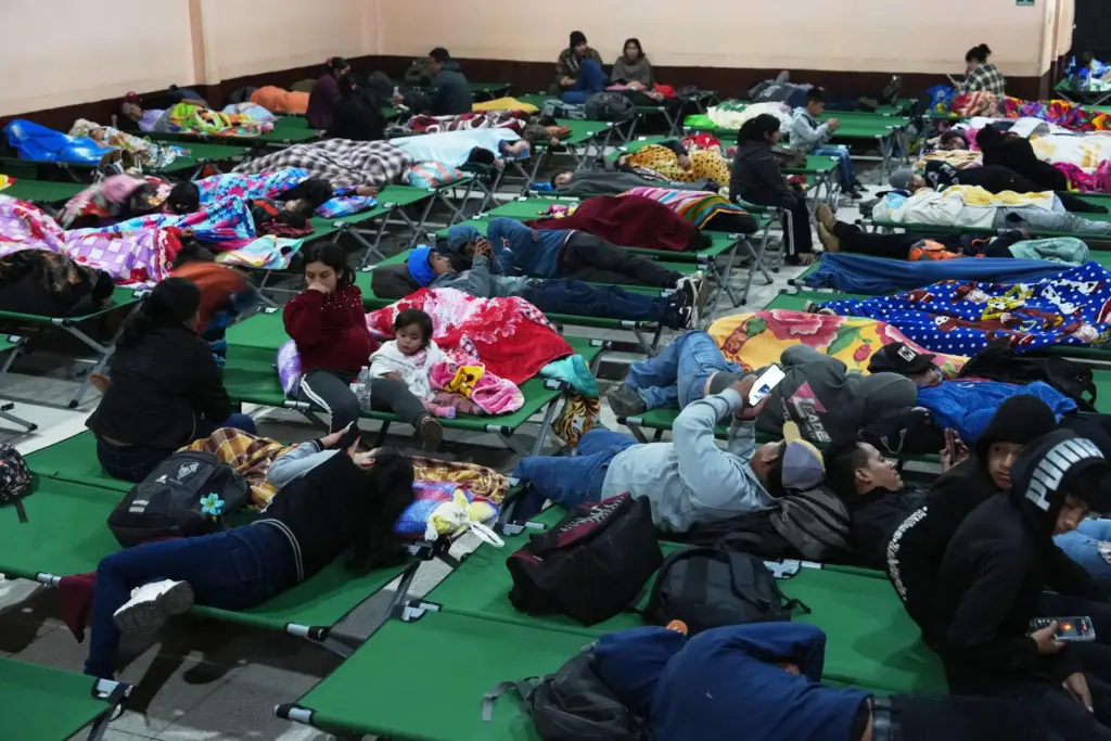 Families evacuated from areas surrounding the Fuego Volcano rest at...