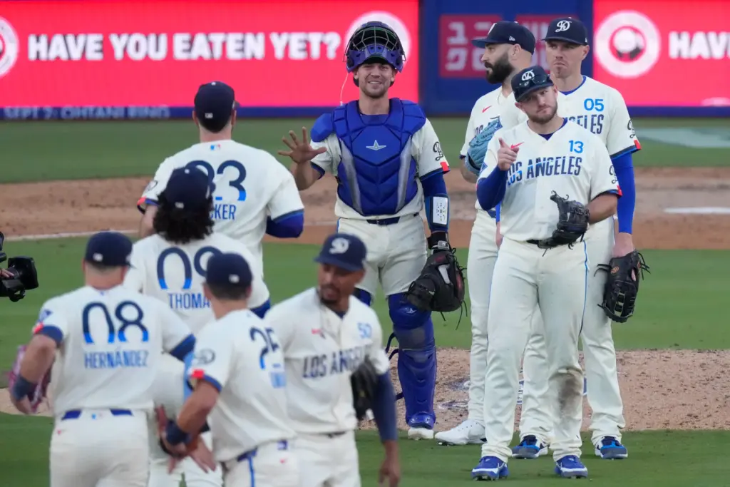 Members of the Los Angeles Dodgers congratulate each other after...