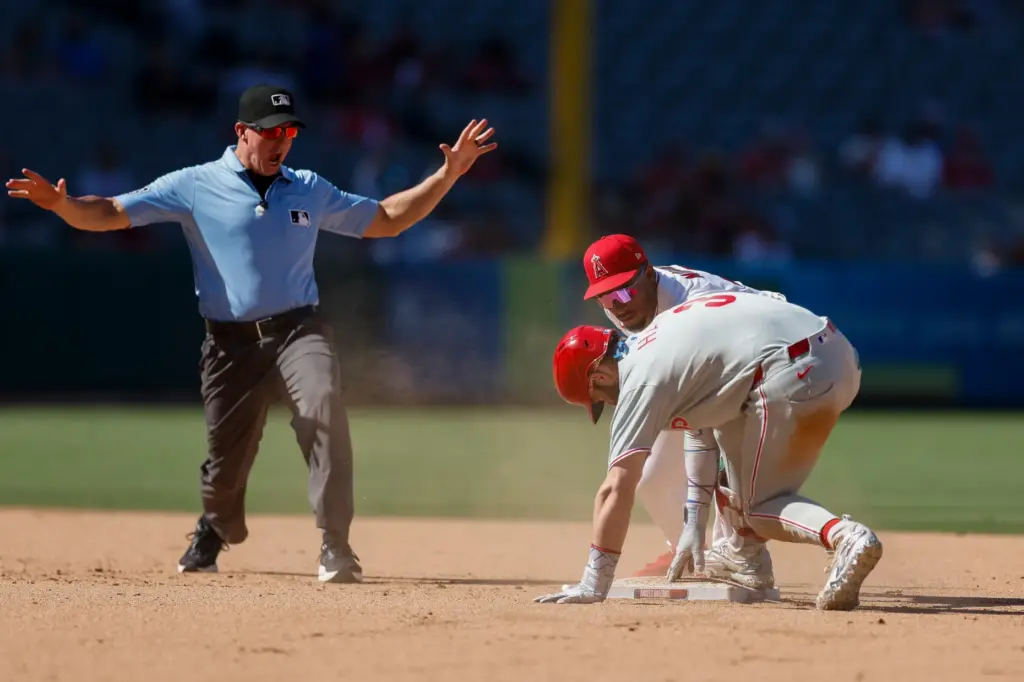 Philadelphia Phillies’ Bryce Harper, front right, slides into second base...