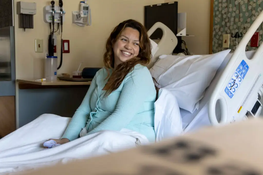 Daniela Contreras smiles to her newborn daughter on Thursday, Aug....