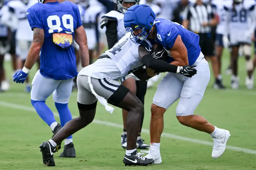 Rams tight end Colby Parkinson, right, is tackled by Dallas...