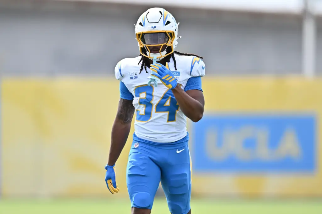 Chargers running back Keaton Mitchell walks on the field during...