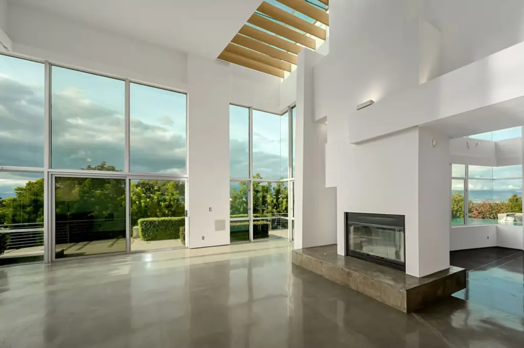 A see-through fireplace anchors the main living space, which features...