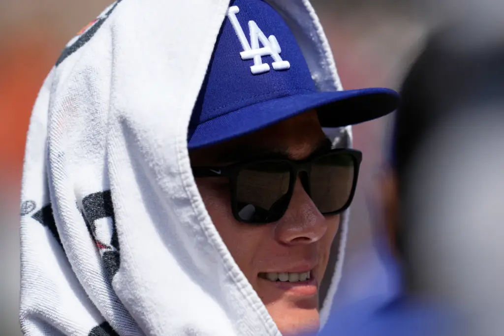 Dodgers’ YoshinobuYamamoto watches against the Detroit Tigers during the second...