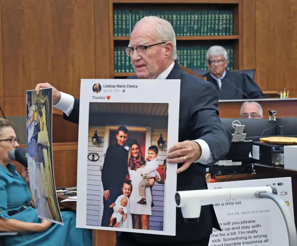 Defense attorney Kevin Reddington holds up a picture of the Clancy family.