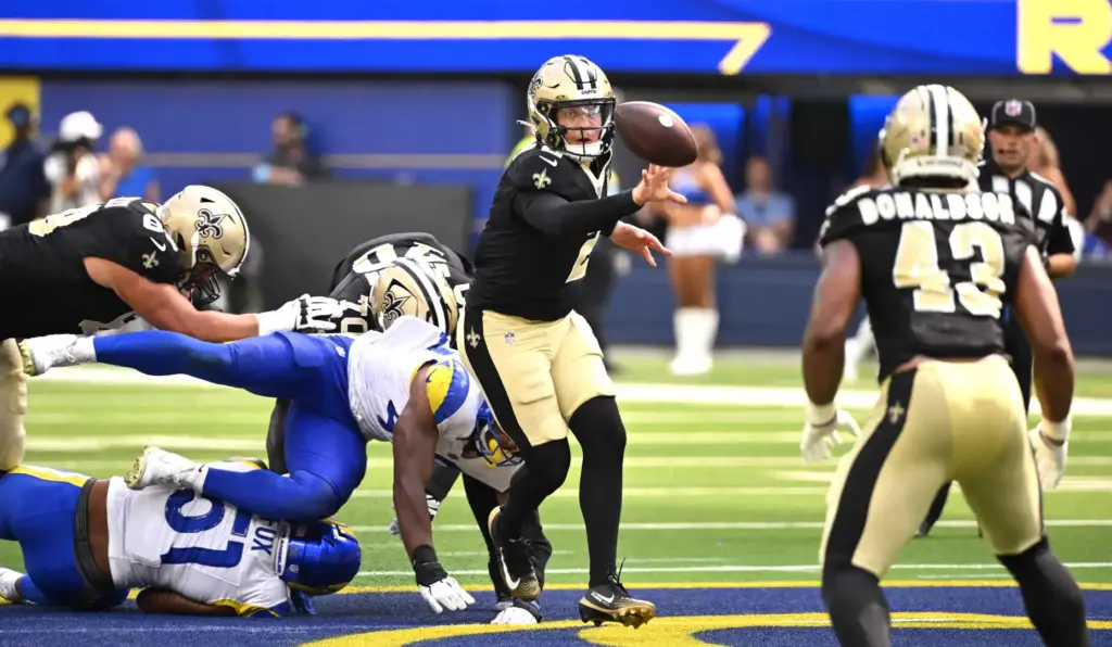 New Orleans Saints quarterback Spencer Rattler (2) shuffles toward running...