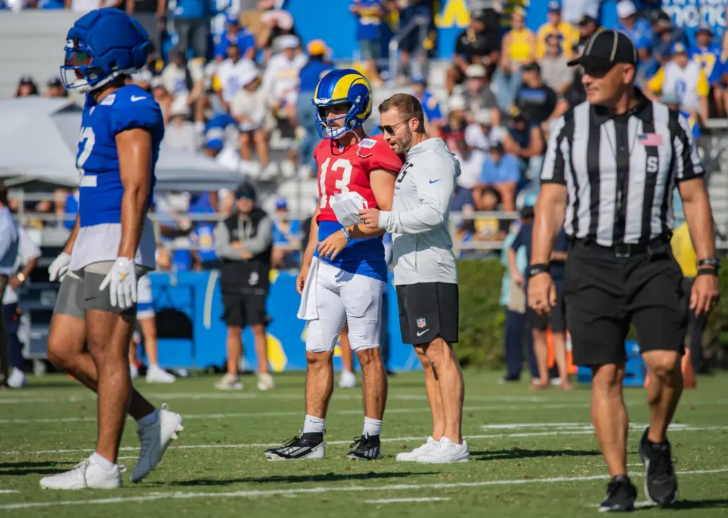 Rams coach Sean McVay, right, chats with quarterback Stetson Bennett...