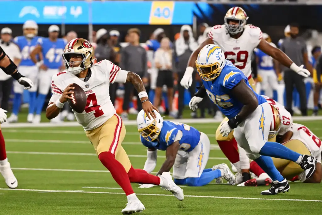 San Francisco 49ers quarterback Adrian Martinez scrambles for a 9-yard...
