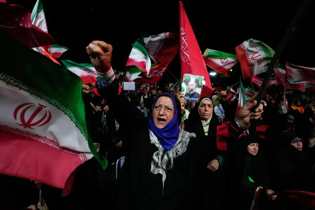A pro-government demonstrator chants slogan during a gathering in a square in Tehran.
