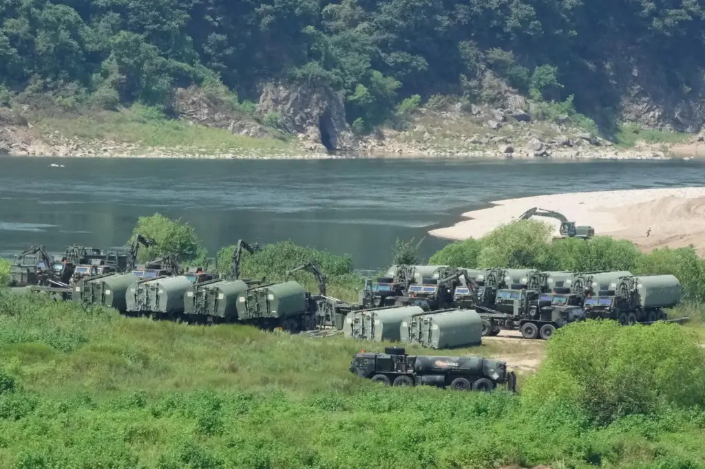 The U.S. Army’s armored vehicles gather to cross a river...