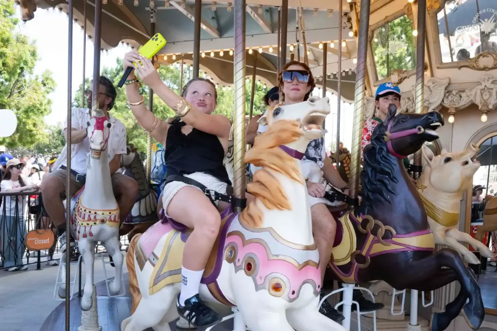 Festivalgoers ride a carousel during the Daisy Chain Fields music...
