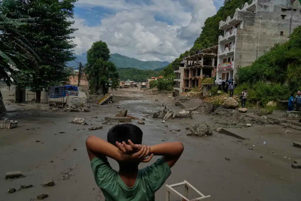 A boy looks at the devastation caused by flash flooding along the Trishuli River.