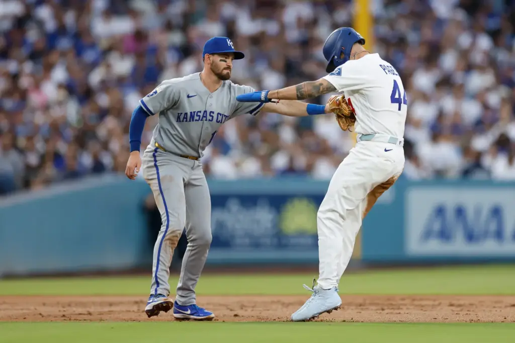 Kansas City Royals third baseman Nick Loftin, left, tags out...