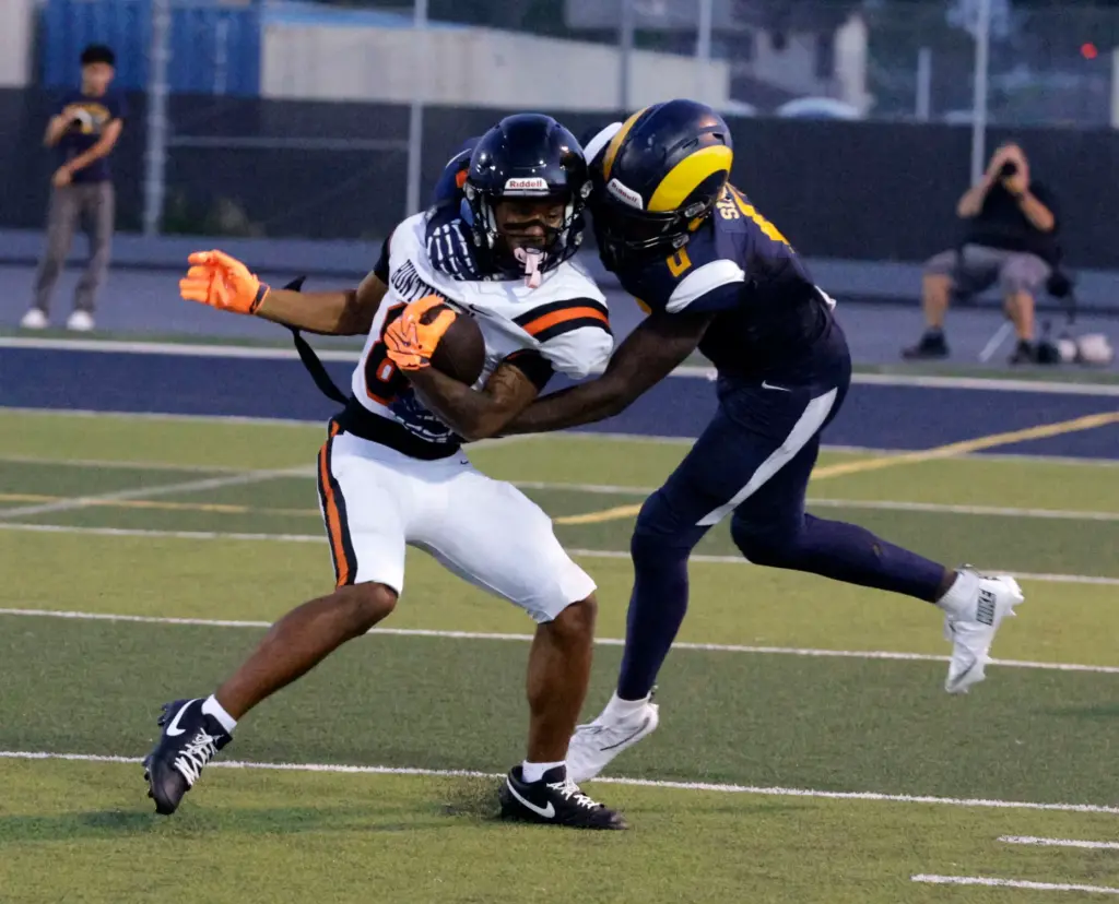 Millikans Odell Simms Jr. (0) tries to take down Huntington...