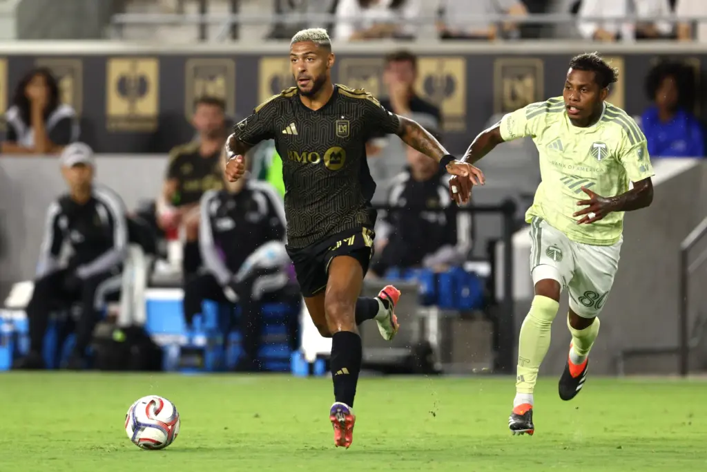 LAFC forward Denis Bouanga, left, moves the ball as Portland...
