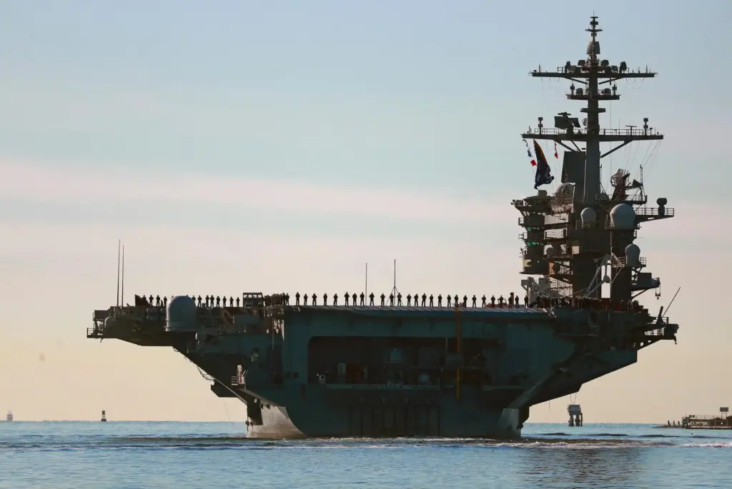 Sailors and Marines line the deck of aircraft carrier USS Abraham Lincoln.