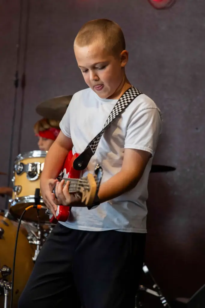 Jacob Kelly, 10, focuses on playing the guitar during rehearsal...