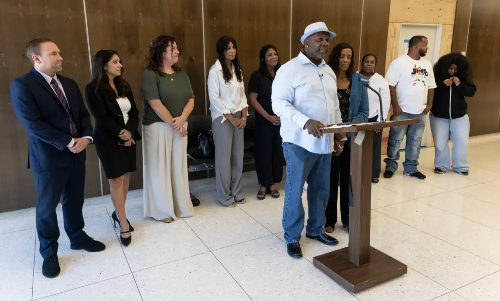 Surrounded by family and staff from The Innocence Center, Guy...