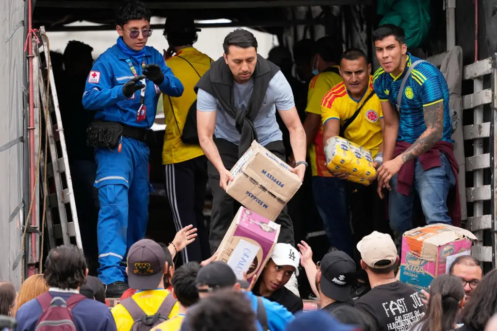 Volunteers in Bogota, Colombia, sort aid for people affected by...