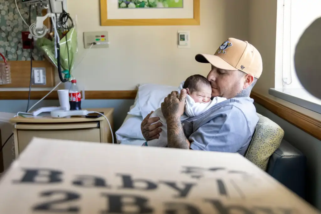 Jaciel Marcavo holds his newborn daughter, Delilah, on Thursday, Aug....
