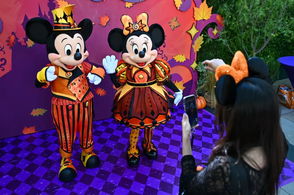 Mickey and Minnie Mouse show off their new Halloween costumes...